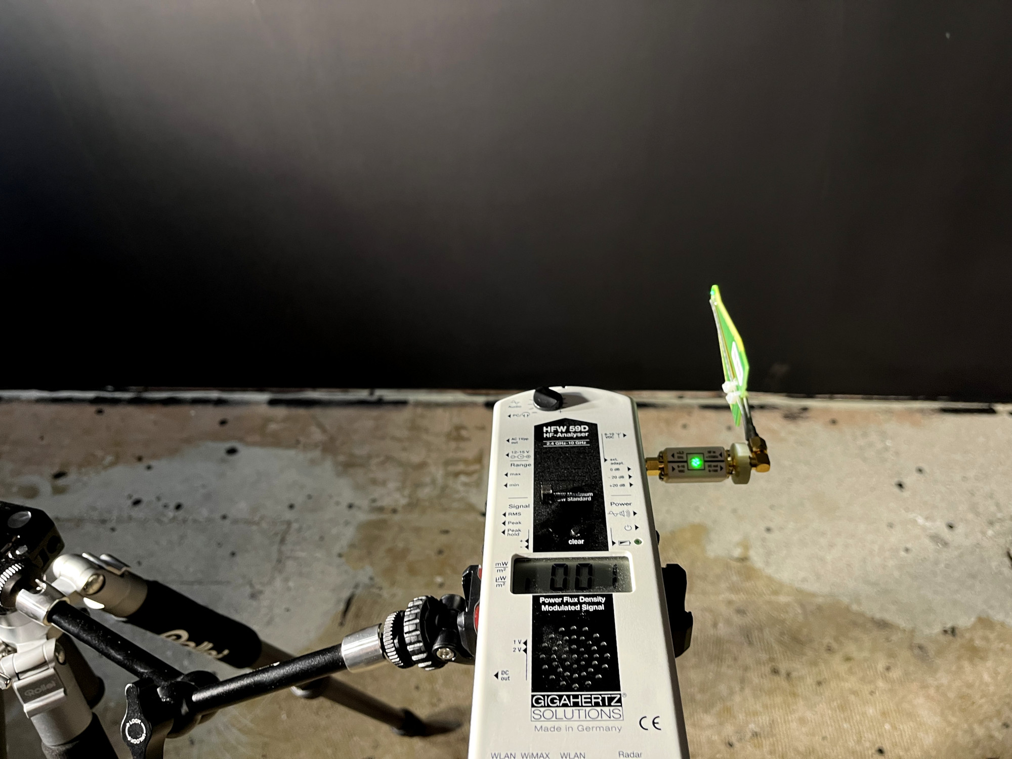 Gigahertz Solutions measuring device in front of a black wall with shielding paint